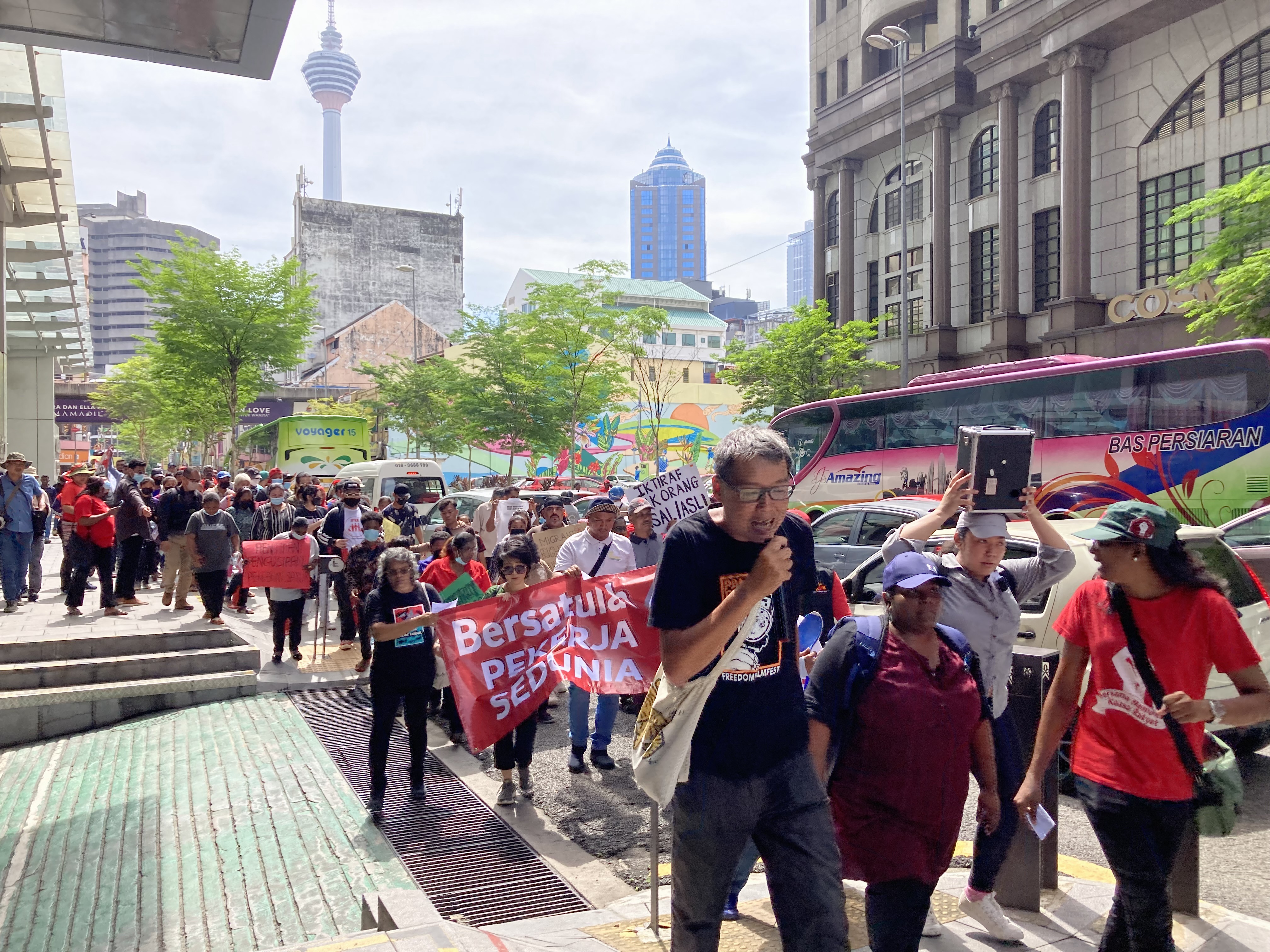 Choon Chon Kai (centre, with microphone) leads a chant at the 2023 May Day march in Kuala Lumpur, Malaysia. Photograph: CLB staff