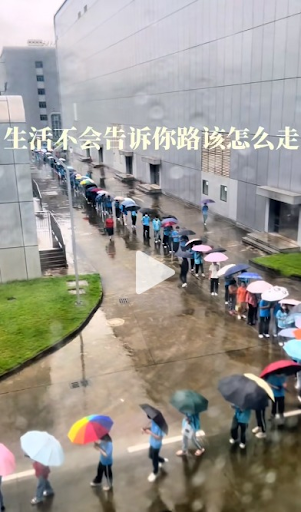 Zhongshan Eurotec workers queue for security checks in the rain