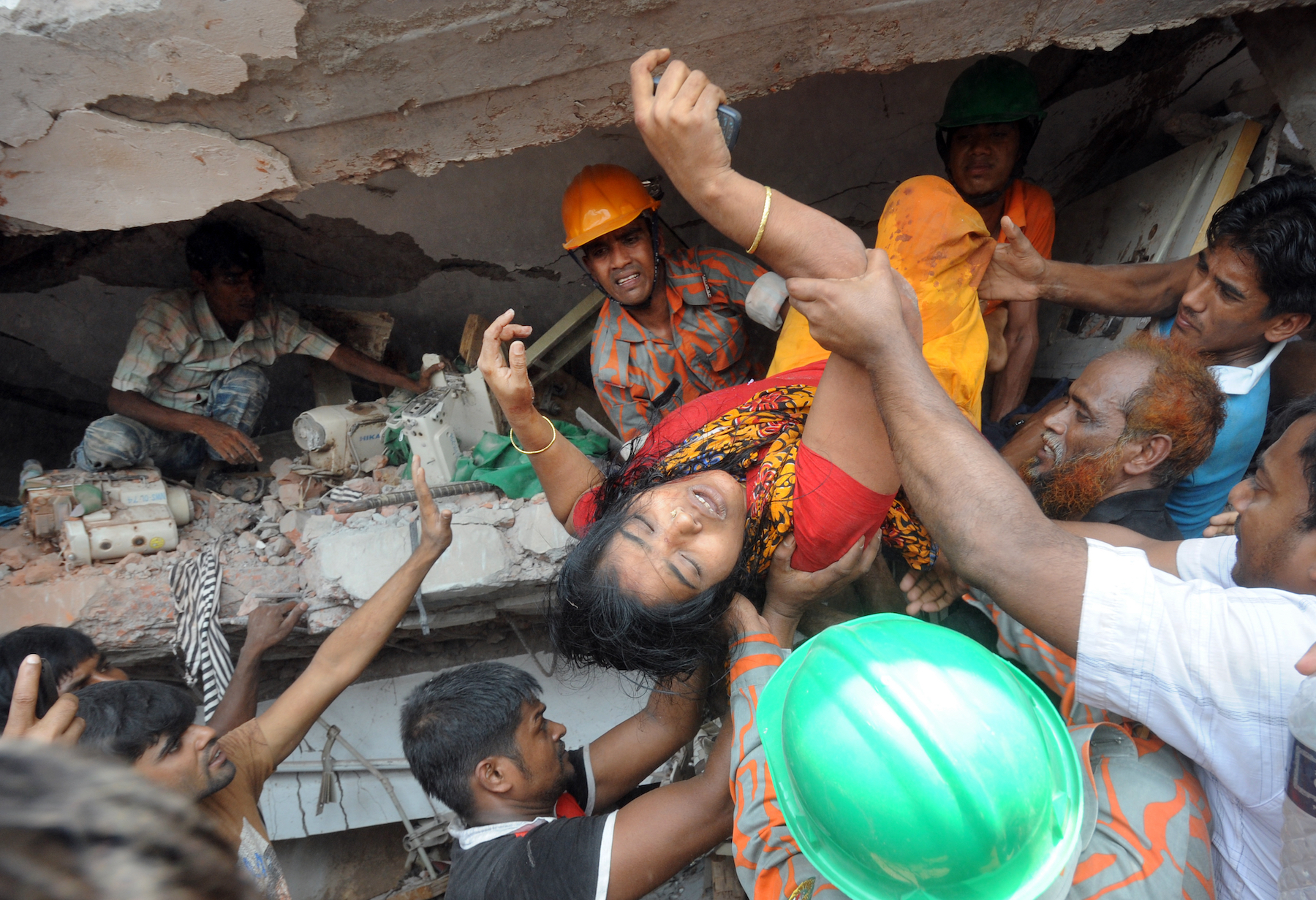 A garment worker is rescued from the Rana Plaza collapse in April 2013