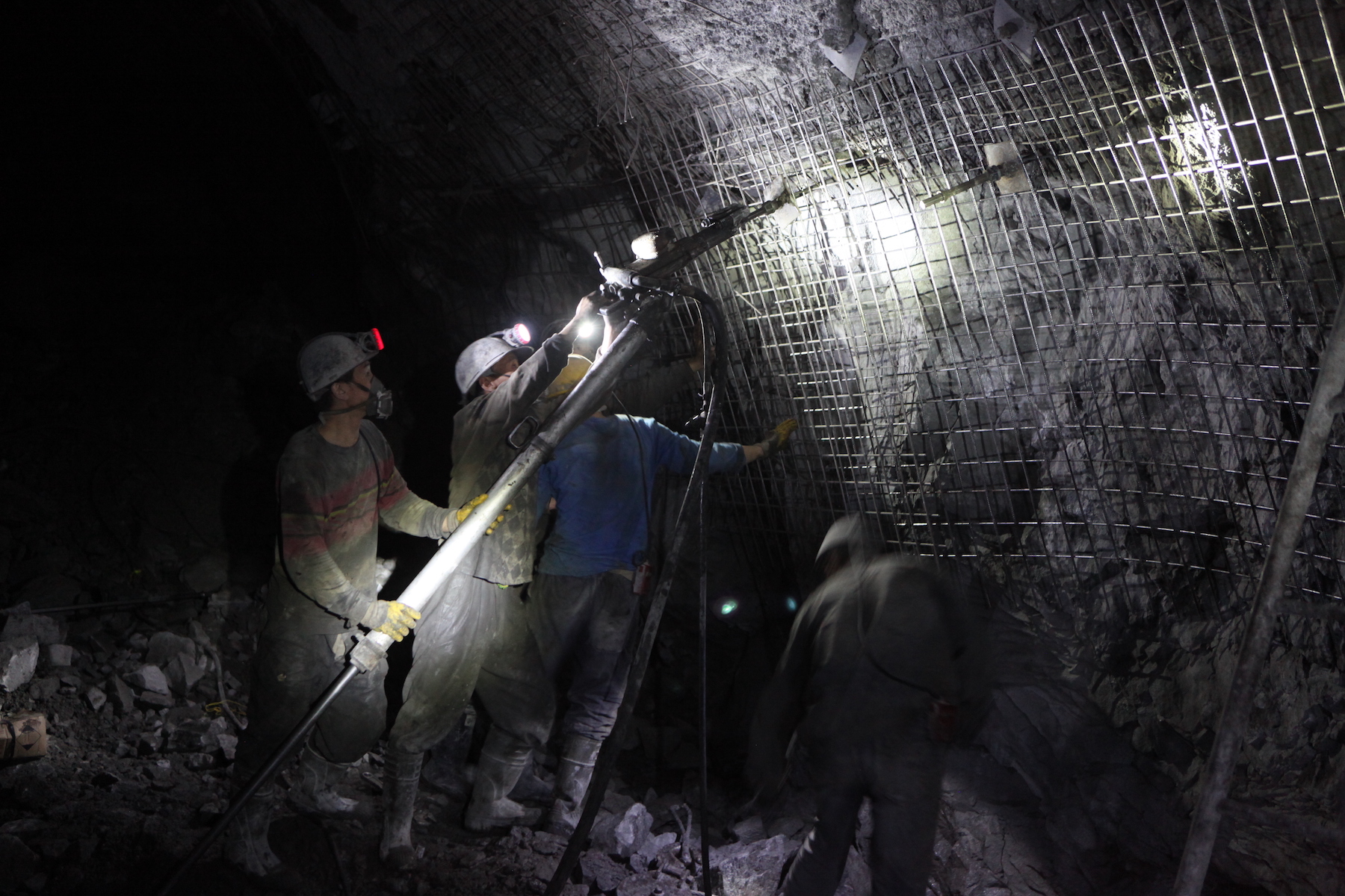 Coal miners conduct work underground in a mine
