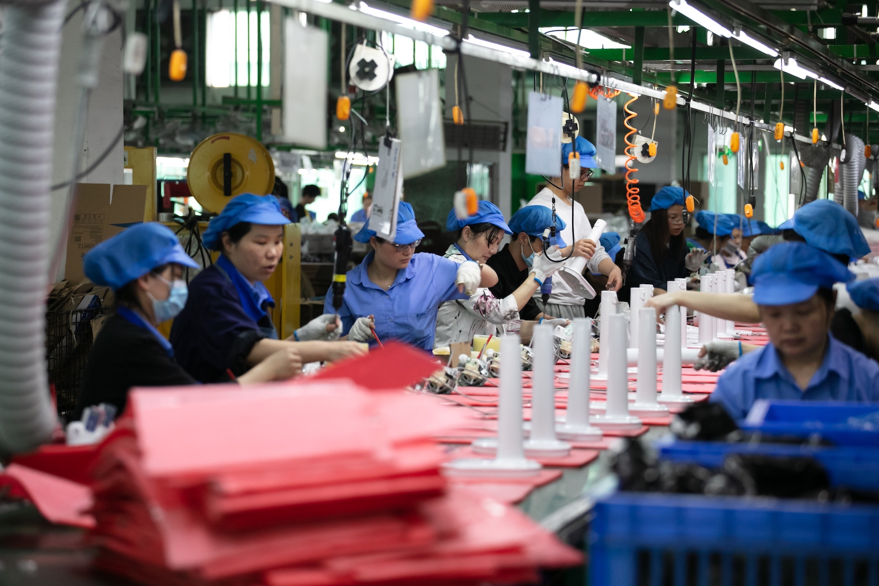 Electronics factory workers on a production line