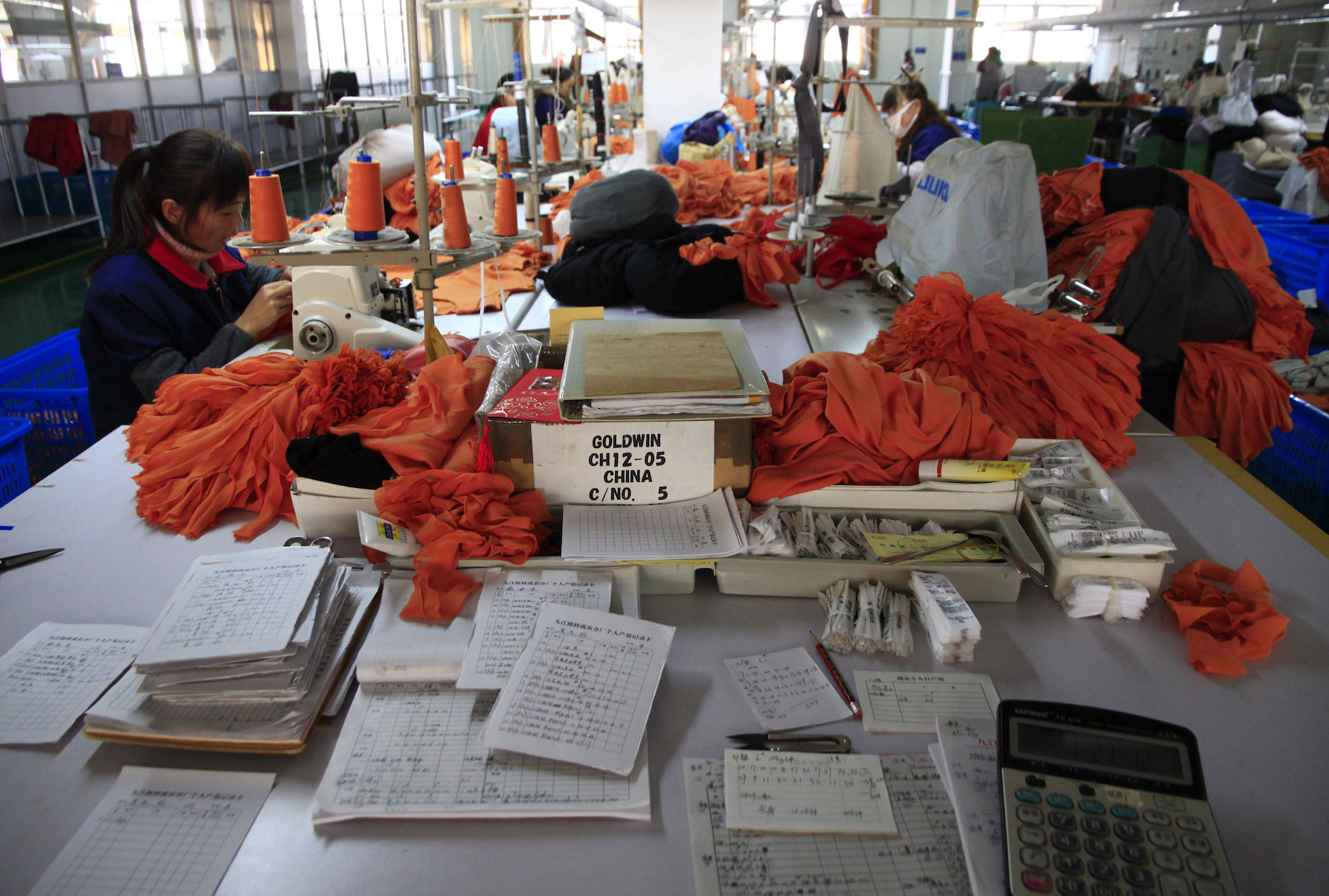 Garment workers in a factory produce clothes