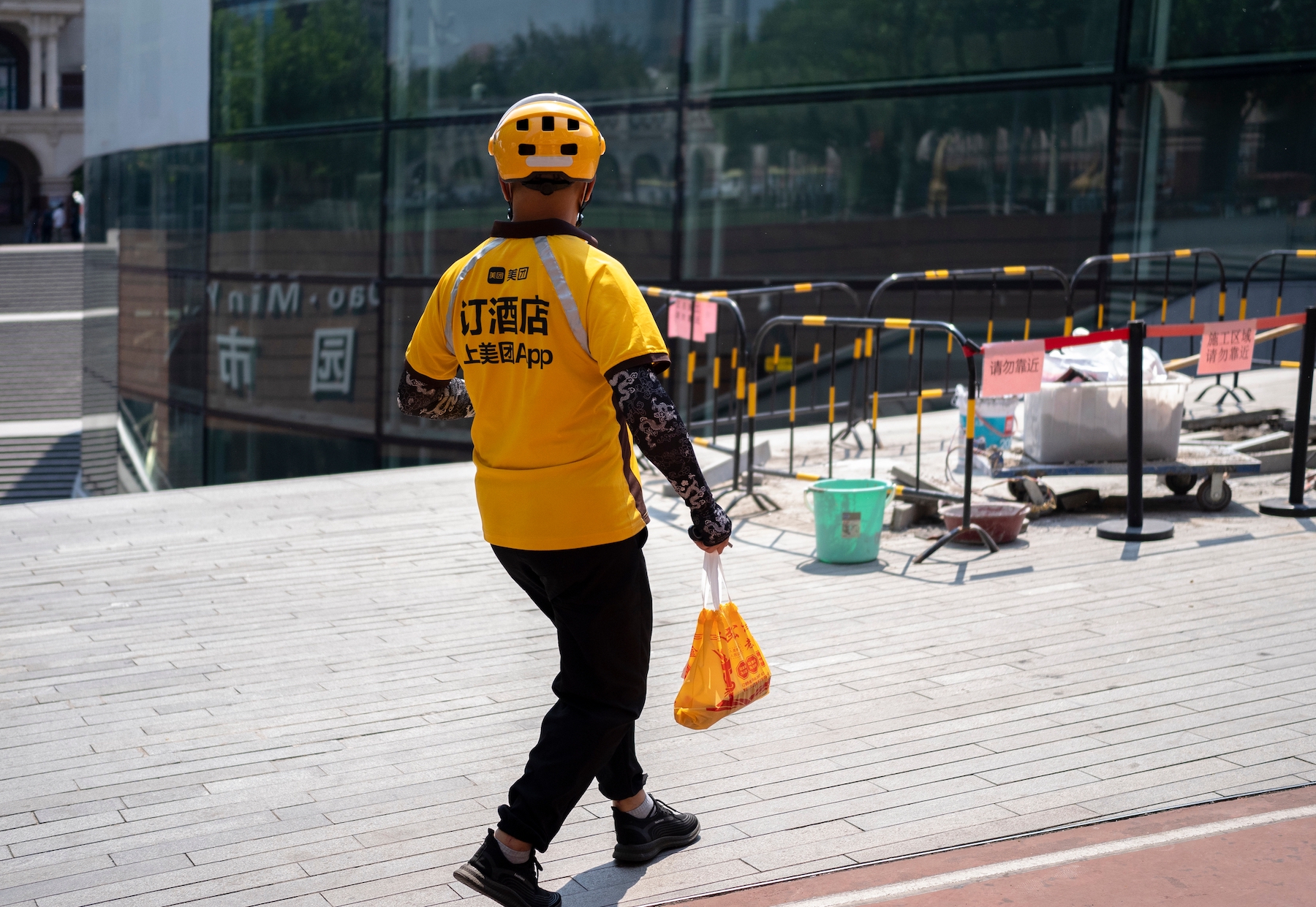 A Meituan food delivery worker delivers a meal on foot