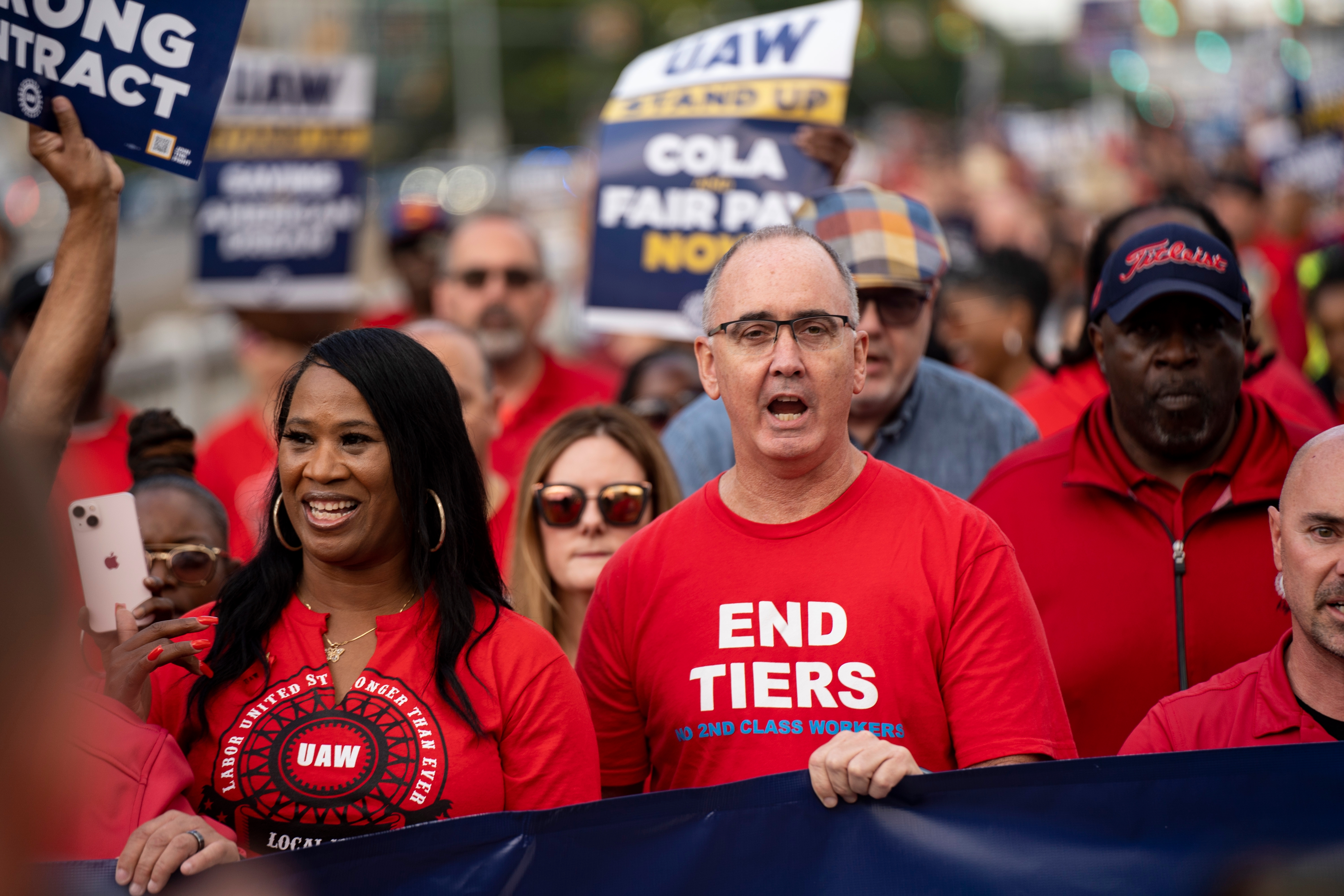 Photo: UAW president leading a march in the 2023 strike and collective bargaining