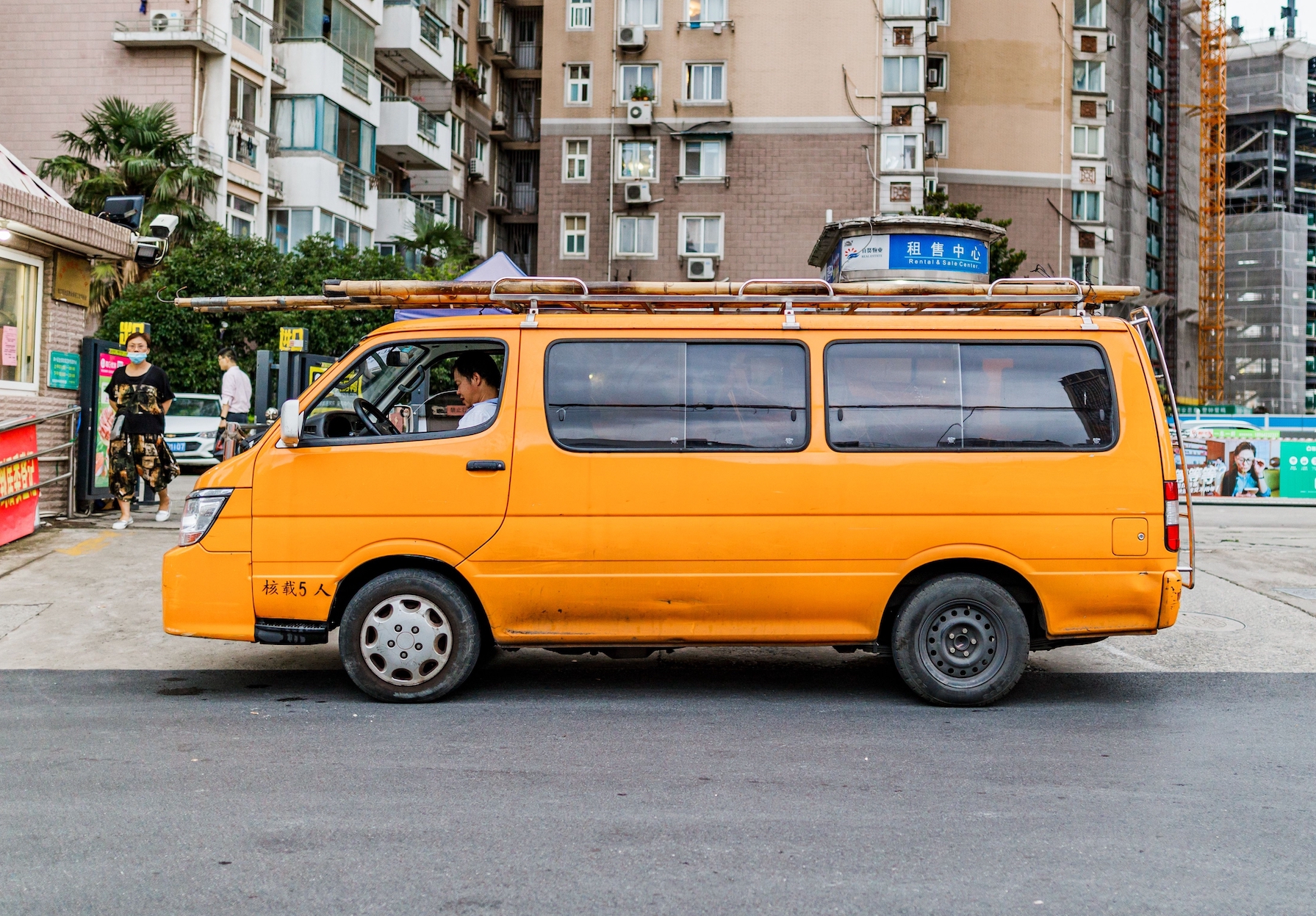 A worker sits in an orange van