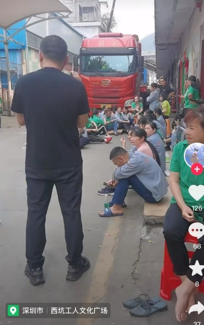 Workers sat in front of the factory. Source: Douyin